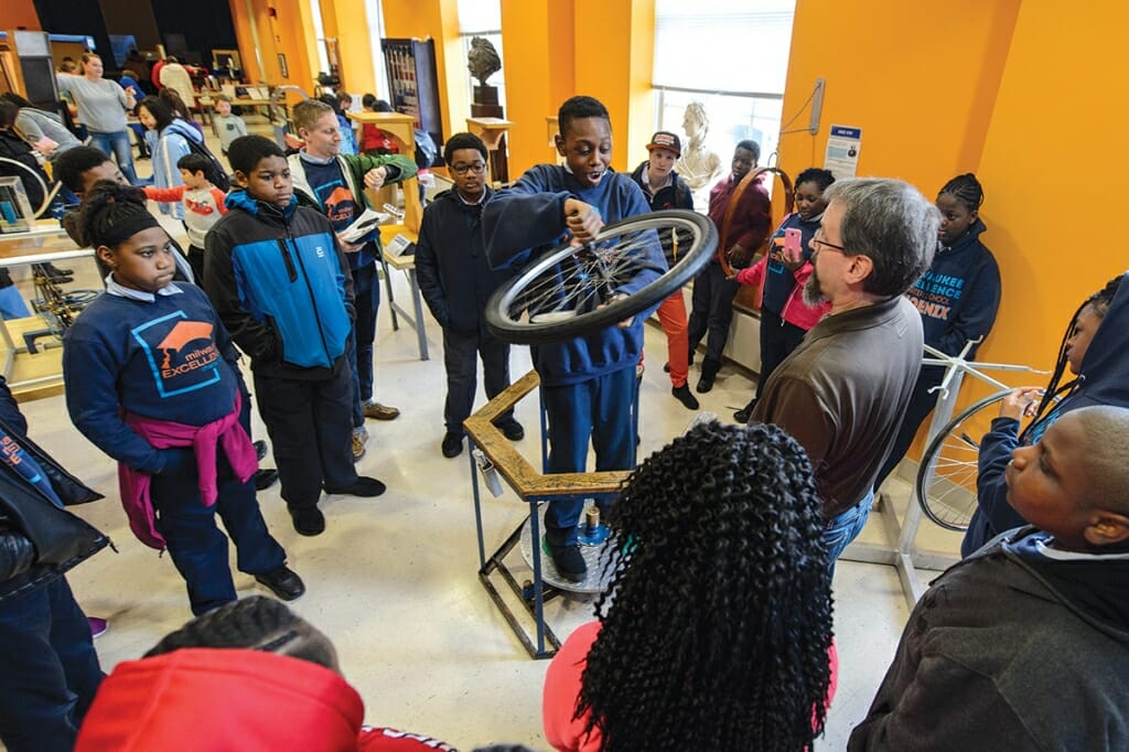 Photo: Student spinning a bicycle wheel