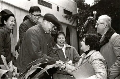 Photo: Nanjing University President Kuang Yaming shakes hands with Millie Shain, wife of UW–Madison Chancellor Irving Shain (right), during the 1979 visit of a UW delegation to China.