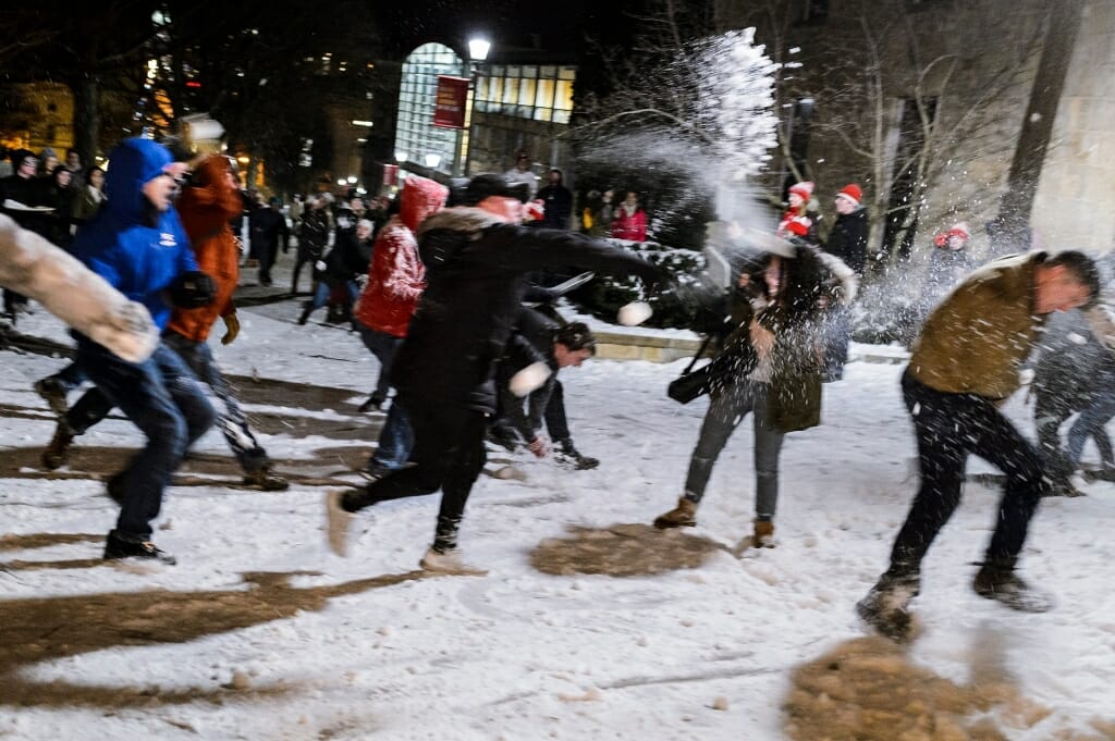 Photo of students pelting each other with snowballs.