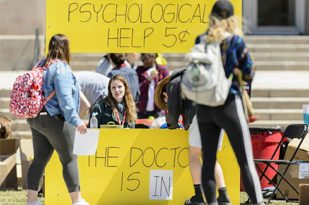 Students register for raffle prizes at a Peanuts-inspired booth hosted by University Health Services.