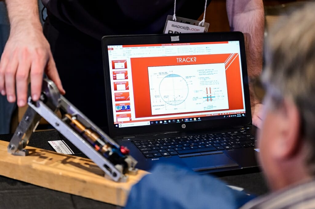 A UW-Madison Badgerloop team member explains components of track design.