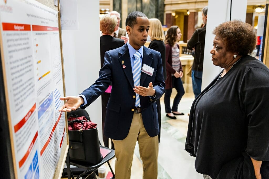 UW-Madison student Negassi Tesfamichael describes his research project on display to Gloria Hawkins, assistant vice provost and director of Chancellor's Scholars and Powers Knapp's Scholarship Programs.