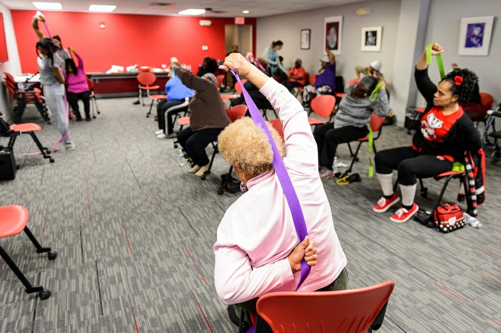 Photo: Pauline Gardner uses a strap to stretch