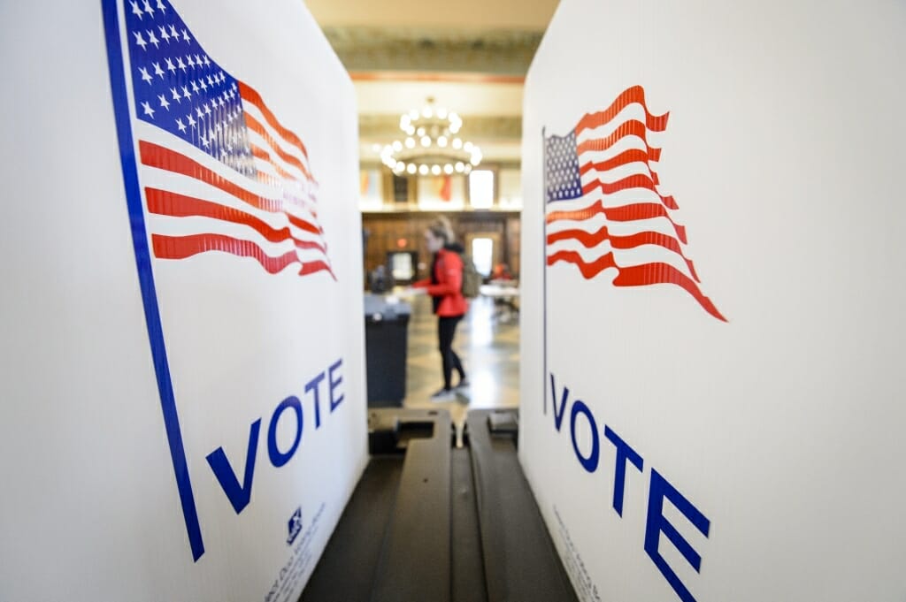 A student places her ballot for the spring election into the tabulating machine in Tripp Commons inside the Memorial Union. It's one of several polling places for UW-Madison students and others living on campus.