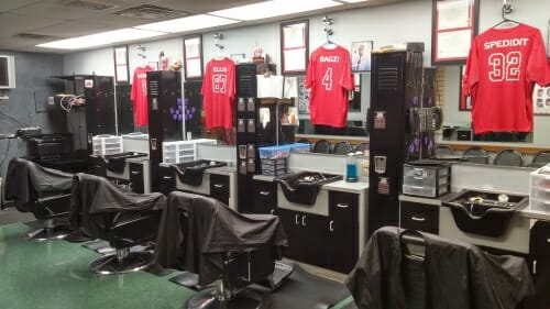 Photo of swivel chairs lining the wall of JP Hair Design, a barbershop on the West Side of Madison.