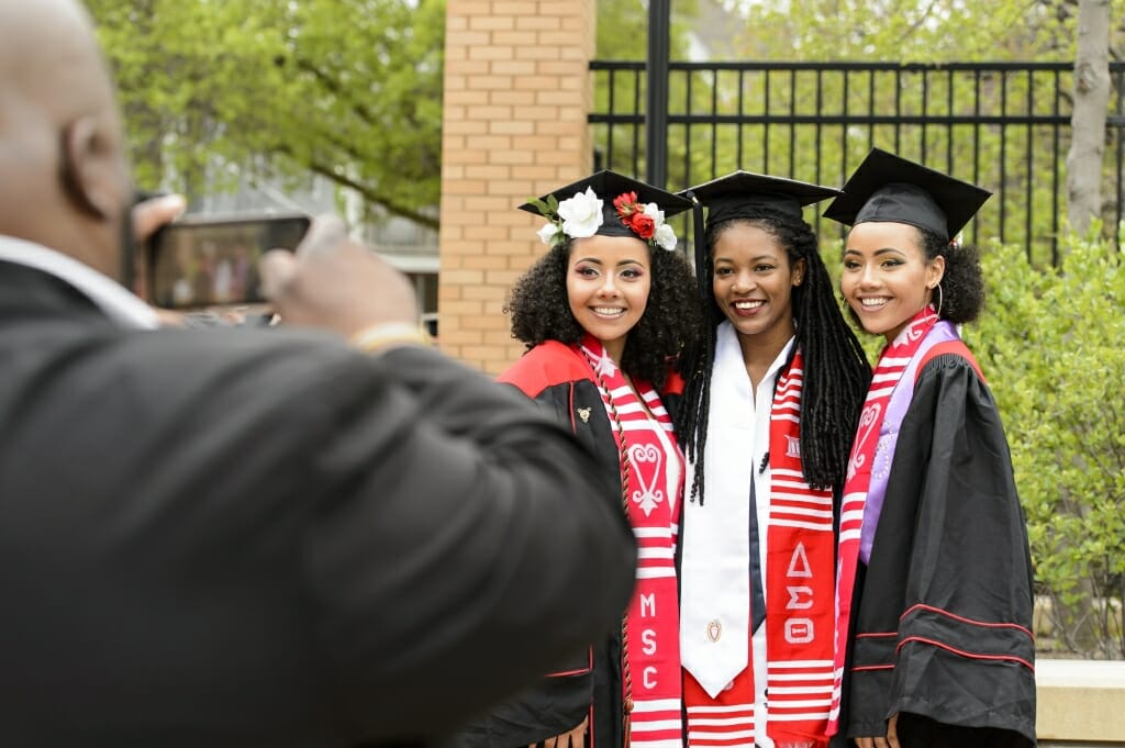 Photo of Alexandra Adams, Akilah Davis and Samantha Adams taking a group photo.