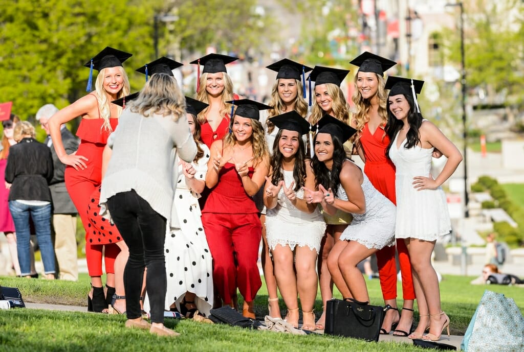 Graduates take advantage of Thursday's warm, sunny weather before Saturday's graduation ceremony. Cooler, rainier weather is expected.