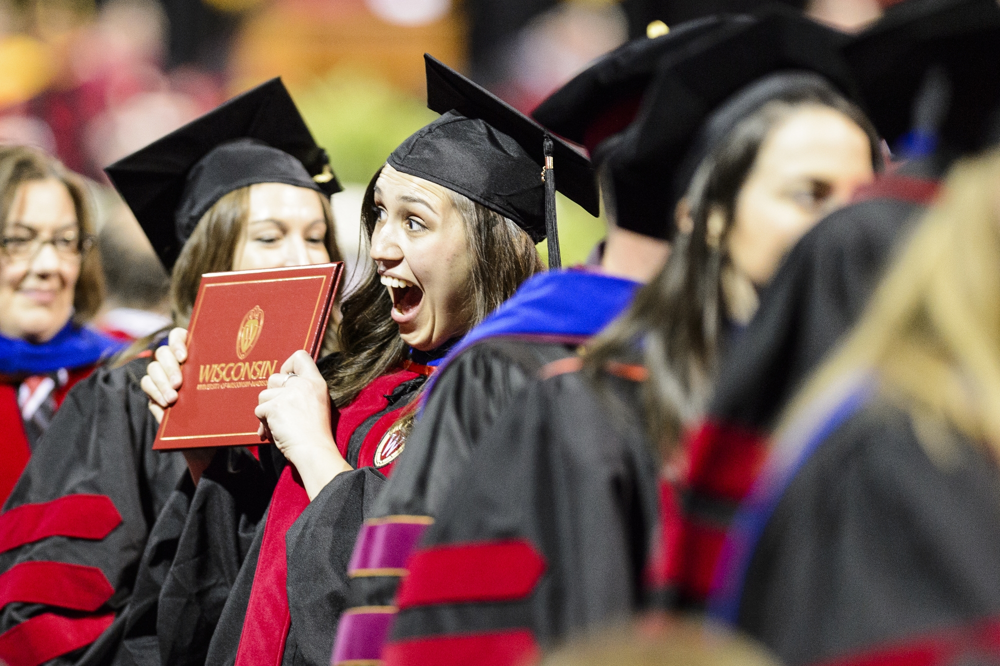 Photo of a graduate with a huge smile.