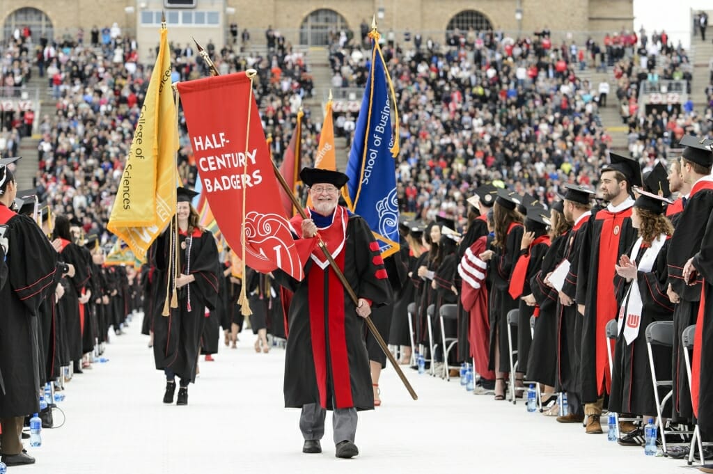 Photo of flag bearers making their way in during the opening procession.