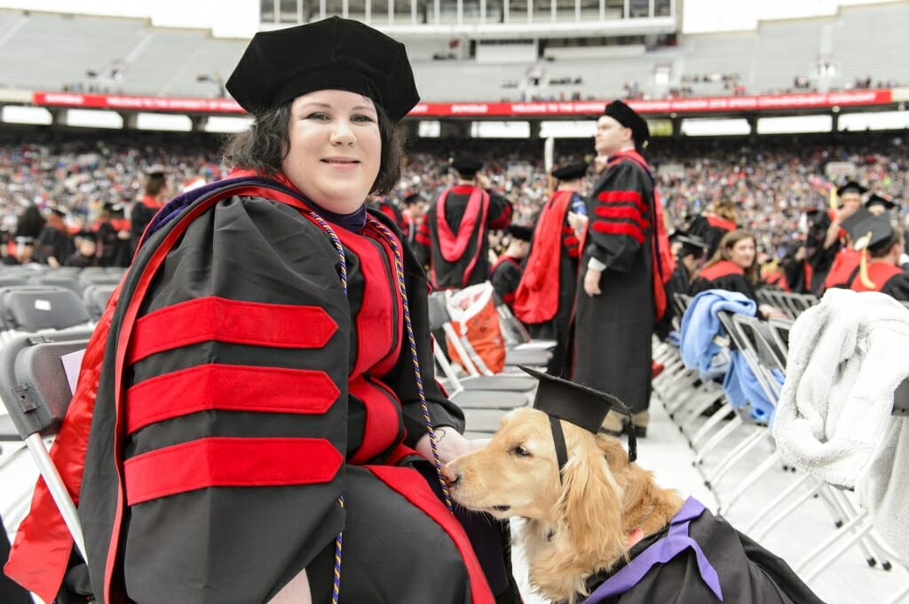 Photo of Sara Conrad and her dog, Renee, sharing a moment.