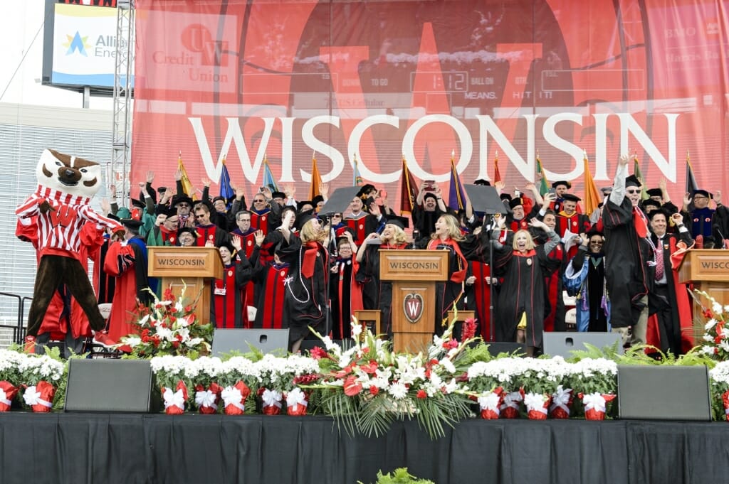 Photo of the entire platform party and Bucky Badger jumping around.