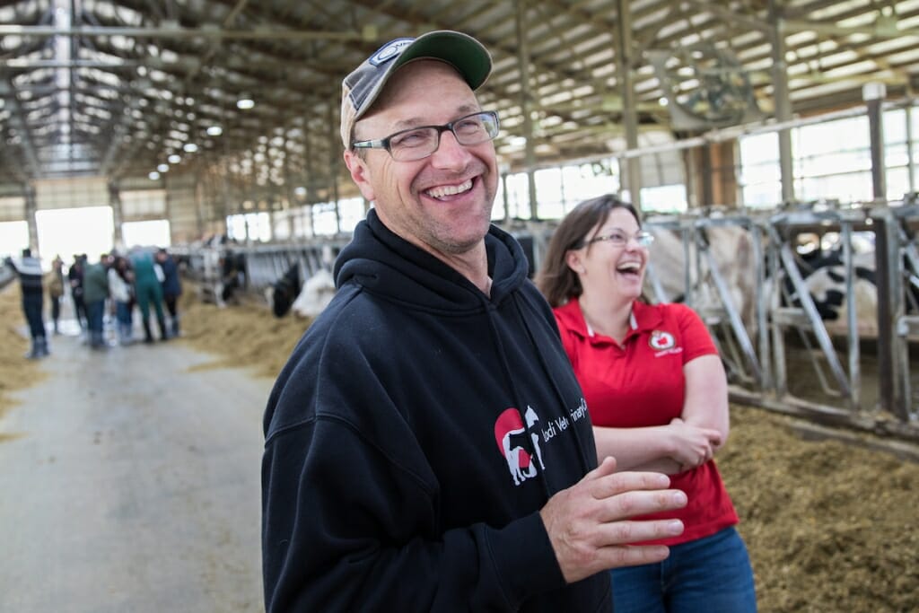 Photo: Mitch Breunig smiling in cow barn