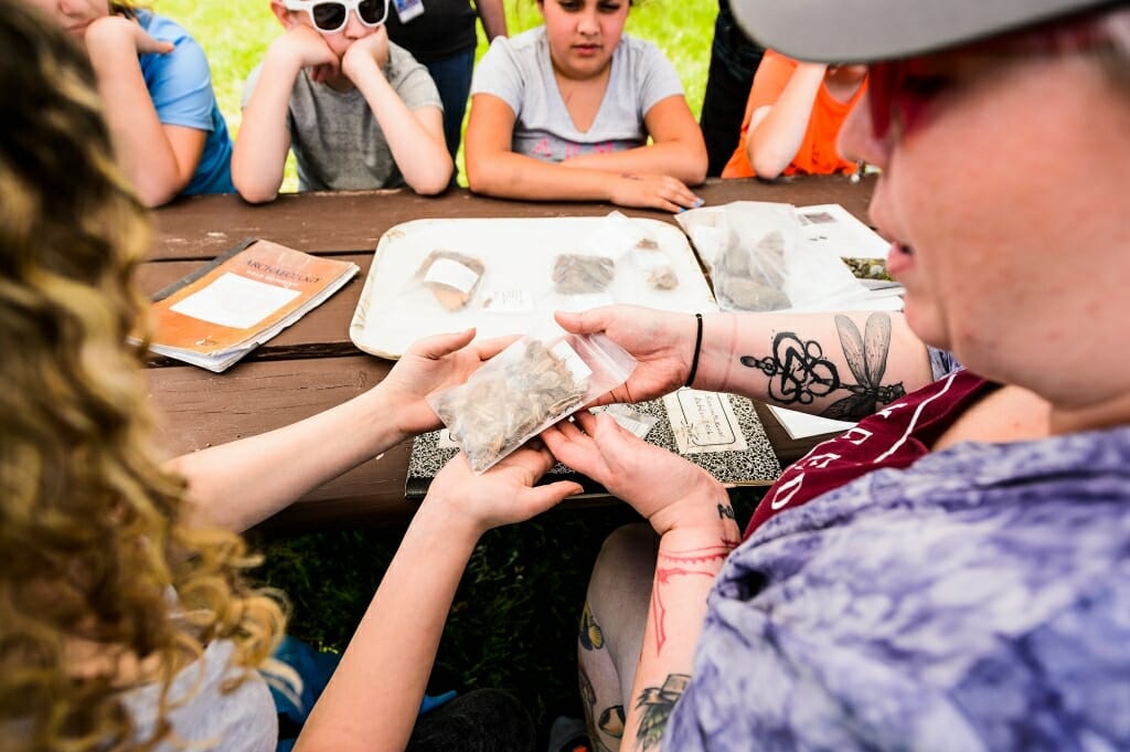 Photo: Closeup of students holding bag with a rock in it