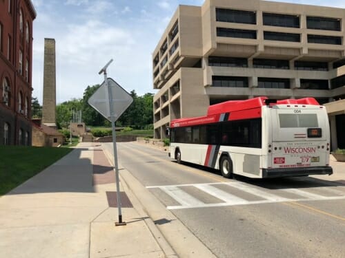 A photo of the 80 city bus driving up Observatory Drive. 