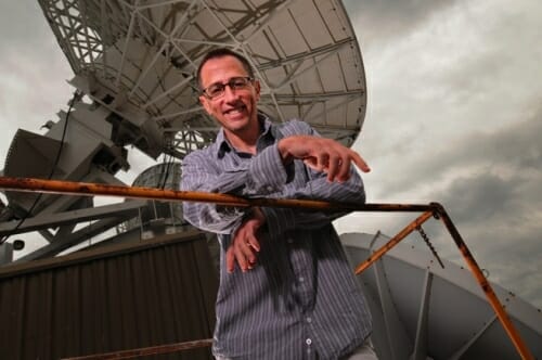 Photo: Jim Kossin on rooftop next to satellite dish