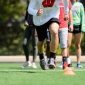 Students wear chest-harness devices capable of tracking the participant's duration of activity, speed, and other GPS-based data as they run drills.