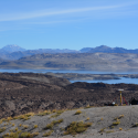 In a scene dominated by volcanism and erosion, Hélène Le Mével (left) and a colleague set up a precision GPS station to measure altitude of a portion of the ancient shoreline of Laguna del Maule, Chile.