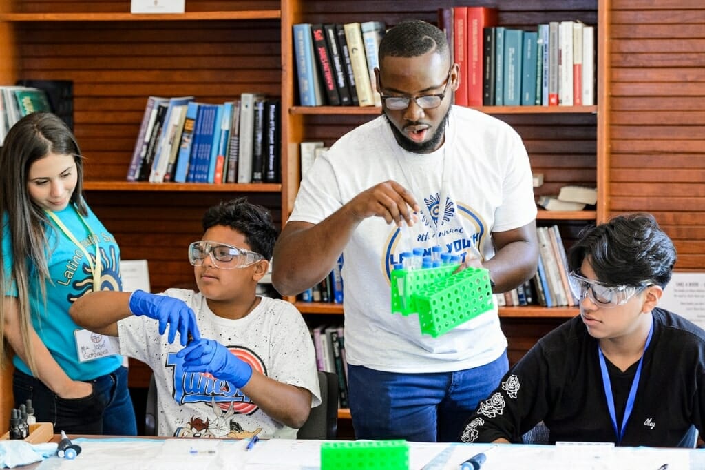 Photo: Man doing experiment with students