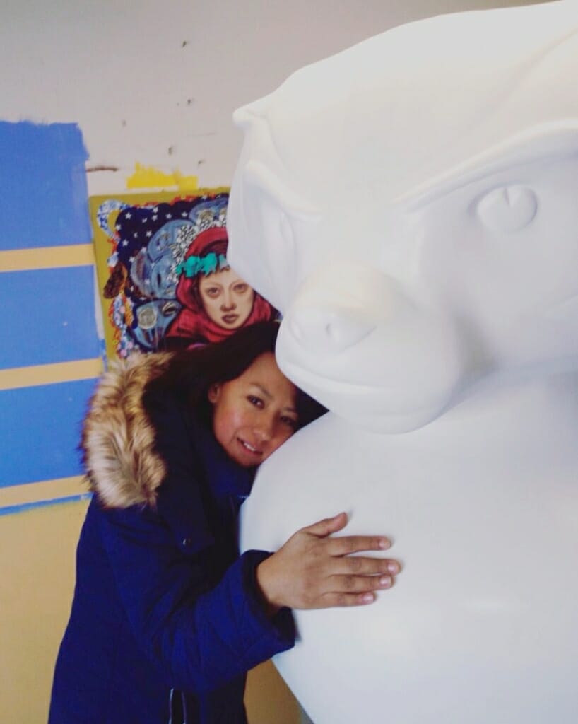 Contreras hugs her blank, 6-foot tall Bucky Badger statue before its transformation into Goodnight Bucky. 