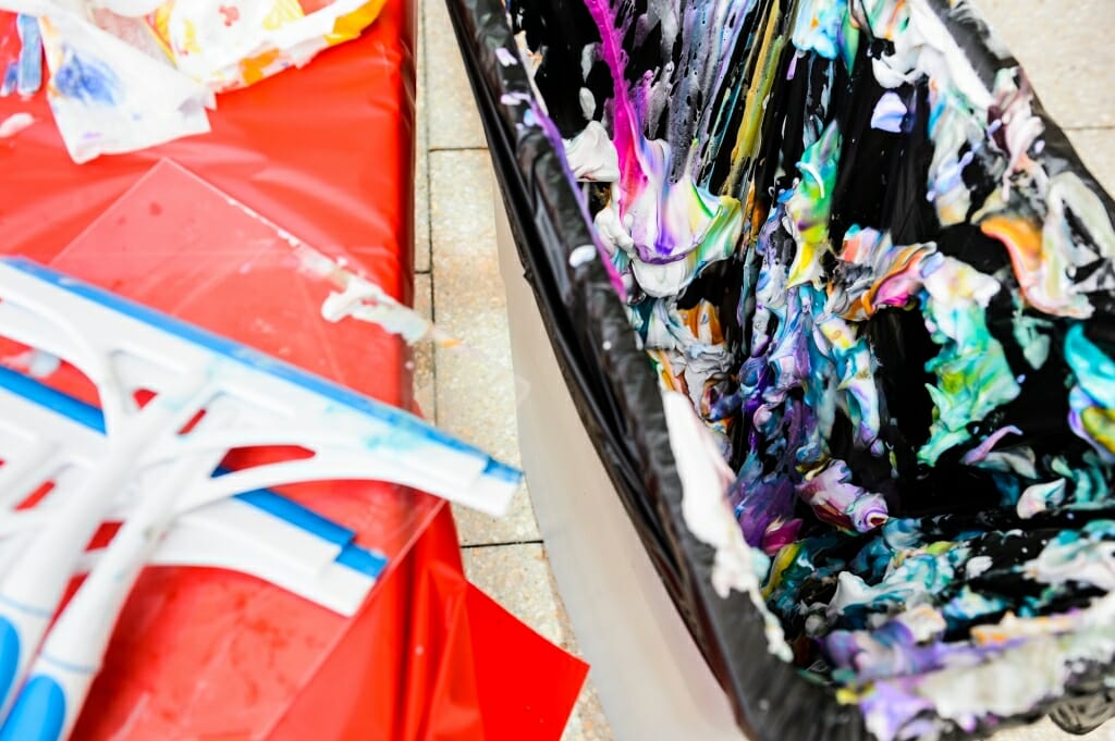 Art can be in the eye of the beholder: A trash can full of colored-shaving cream since squeegeed away from paper prints is pictured.