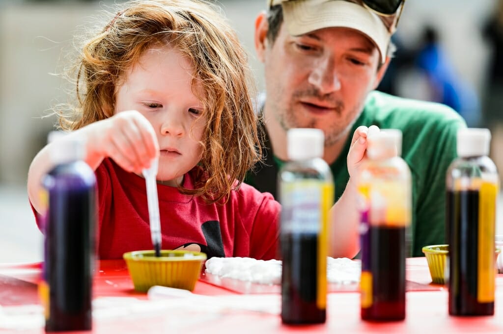 Mike Weiser watches as his daughter, Sylvia, 4, uses drops of food coloring to make shaving-cream art and patterned-paper prints.