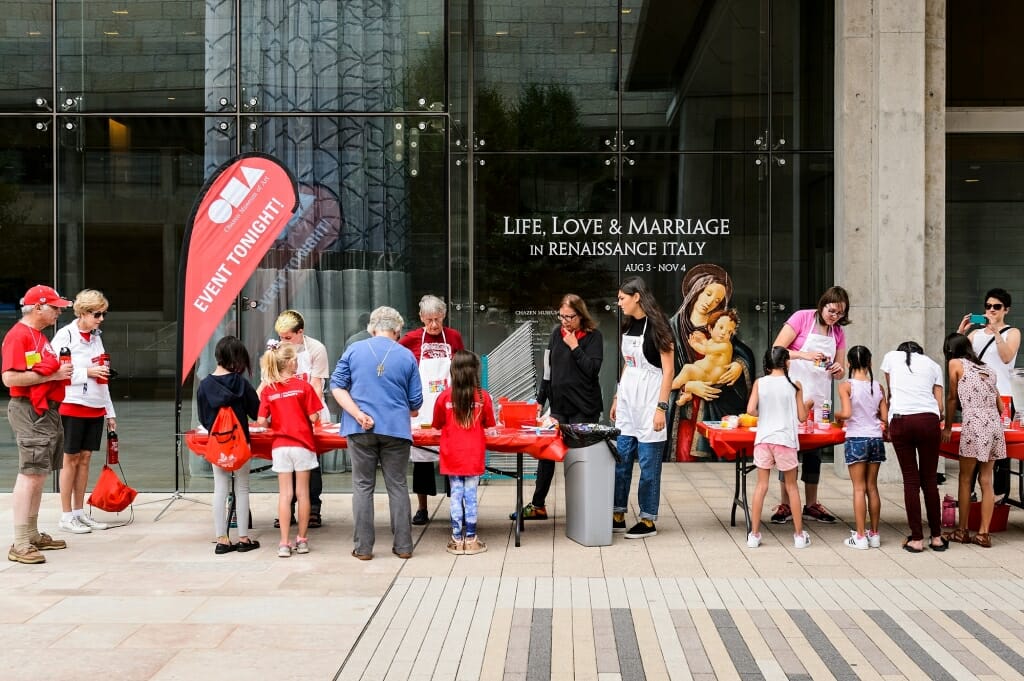 Participants line up to make shaving-cream art and patterned-paper prints during a Chazen Museum of Art-sponsored Summer Spin art activity held outside the museum on July 26. The weekly summer outreach event is open to the public.