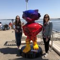 Allyson Casey and Megan Breene stand next to Sunset Bucky, one of 85 unique Bucky Badger statues designed for Bucky on Parade, a public art project.