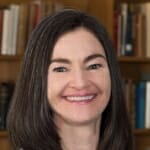 Photo: Lisa Carter standing in front of a bookcase