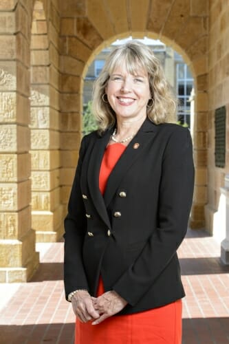 Photo: Lori Reesor standing in front of Bascom Hall arch