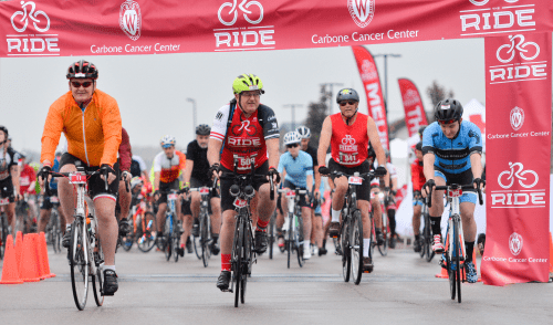 Photo: Four cyclists riding through entrance