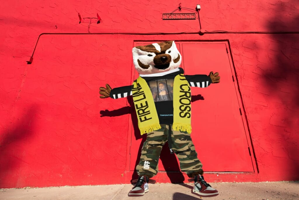 Photo illustration: Bucky Badger against red wall