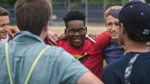 Photo: Group of students with arms around each other's shoulders