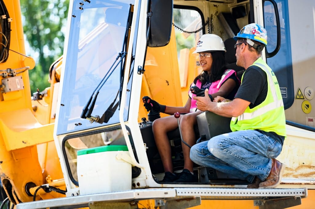 Kassedy Correa, 12, takes control of a crane.