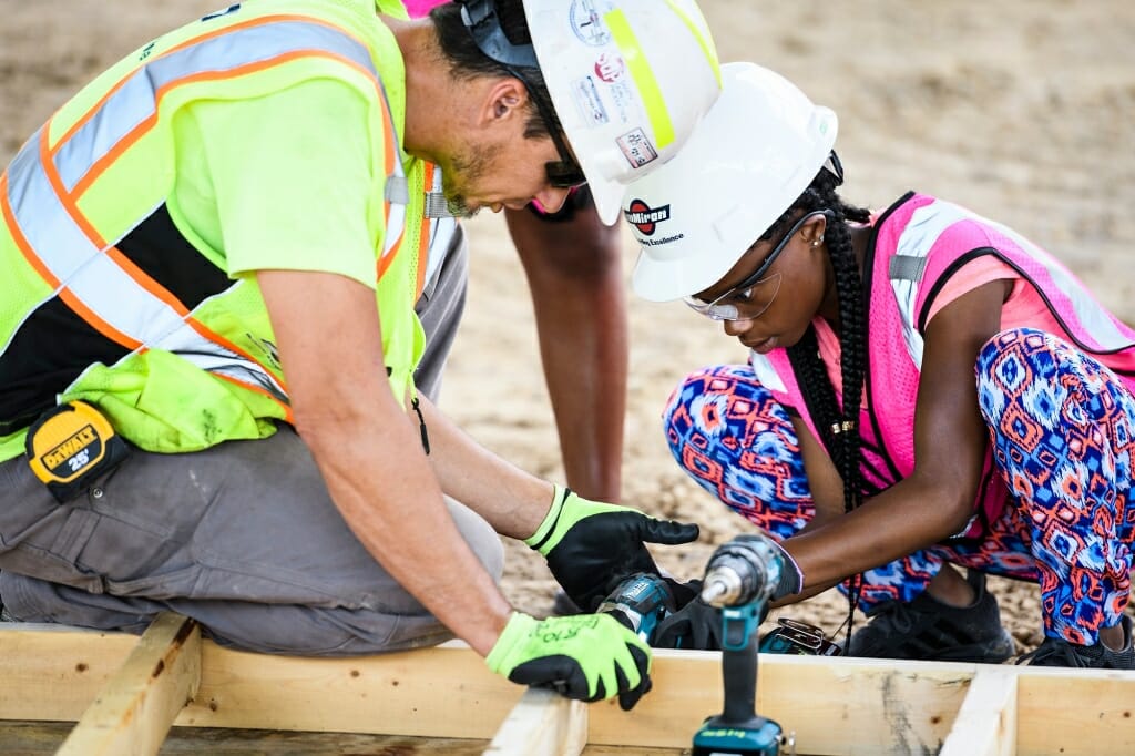 Armani-Raven Nichols, right, learns carpentry skills.