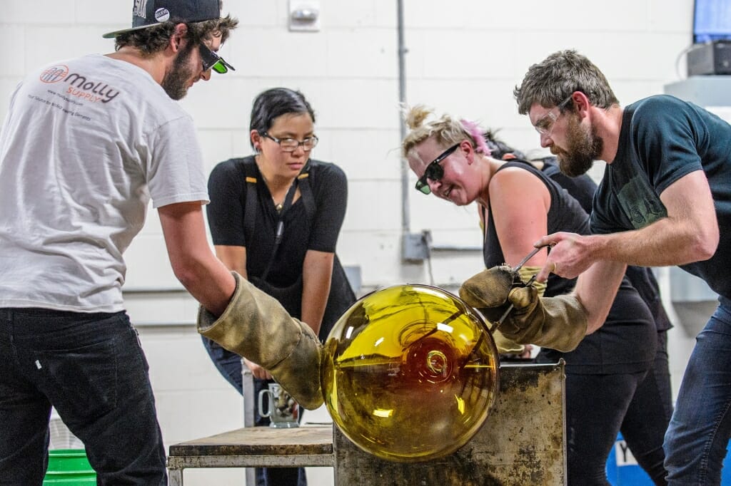 Photo: Students around molten glass project