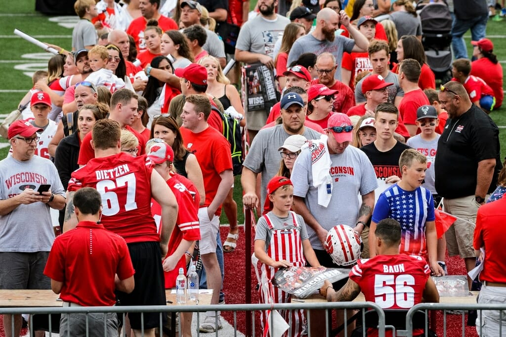 Badger fans line up to collect autographs  from a number of varsity Wisconsin football players.