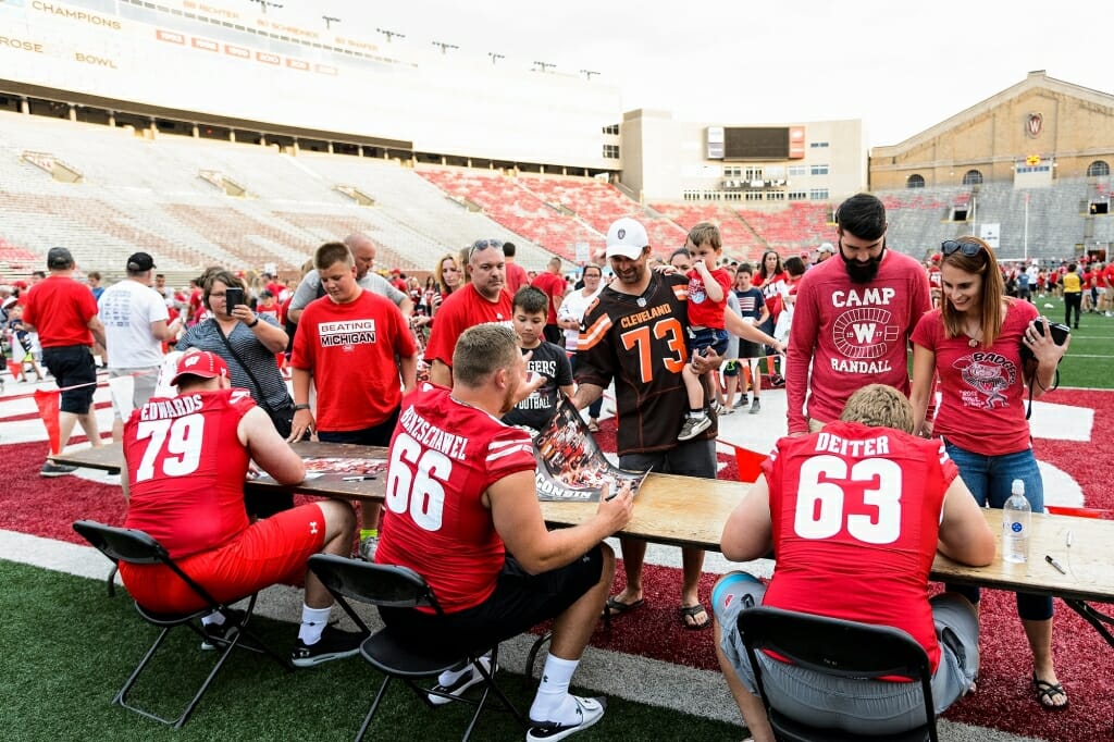 Players sign autographs, and meet, Badger fans.