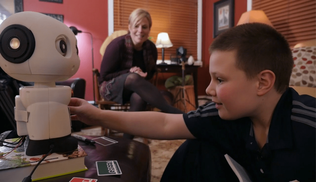 Photo: Child touching robot