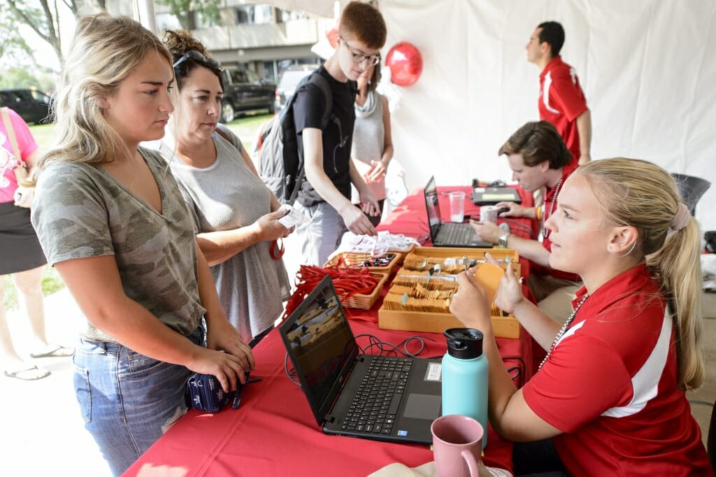 Photo: Employee handing key to student