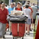 Photo: Student pushing red laundry cart overflowing with things