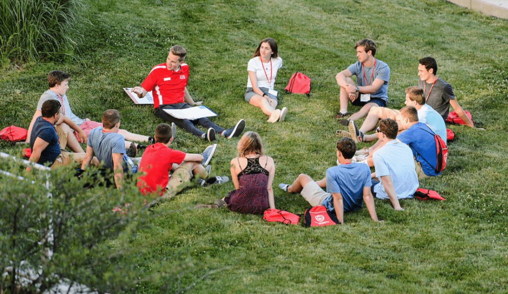 New-student leader Jack Lindenberg, left of center, talks with incoming first-year undergraduates and facilitates a small-group discussion about the challenges new students may face as they transition to campus life during in a Student Orientation, Advising and Registration (SOAR) session.