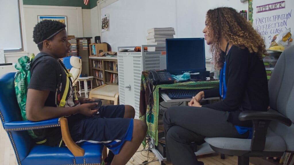 Photo: Teacher and student seated facing each other