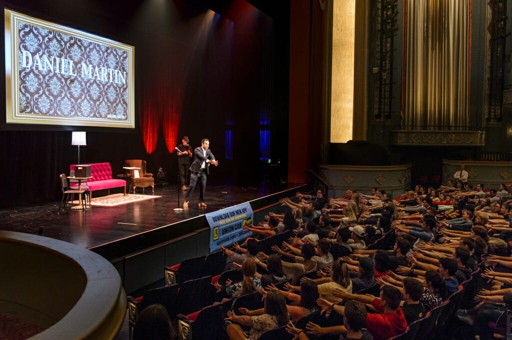 Students watch a magic show featuring Daniel Martin.