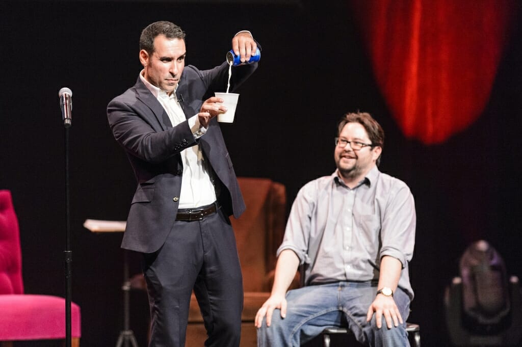 Magician Daniel Martin pulls a few tricks with a volunteer.