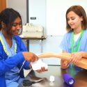 Students participate in a lab to practice bandaging an animal's leg.