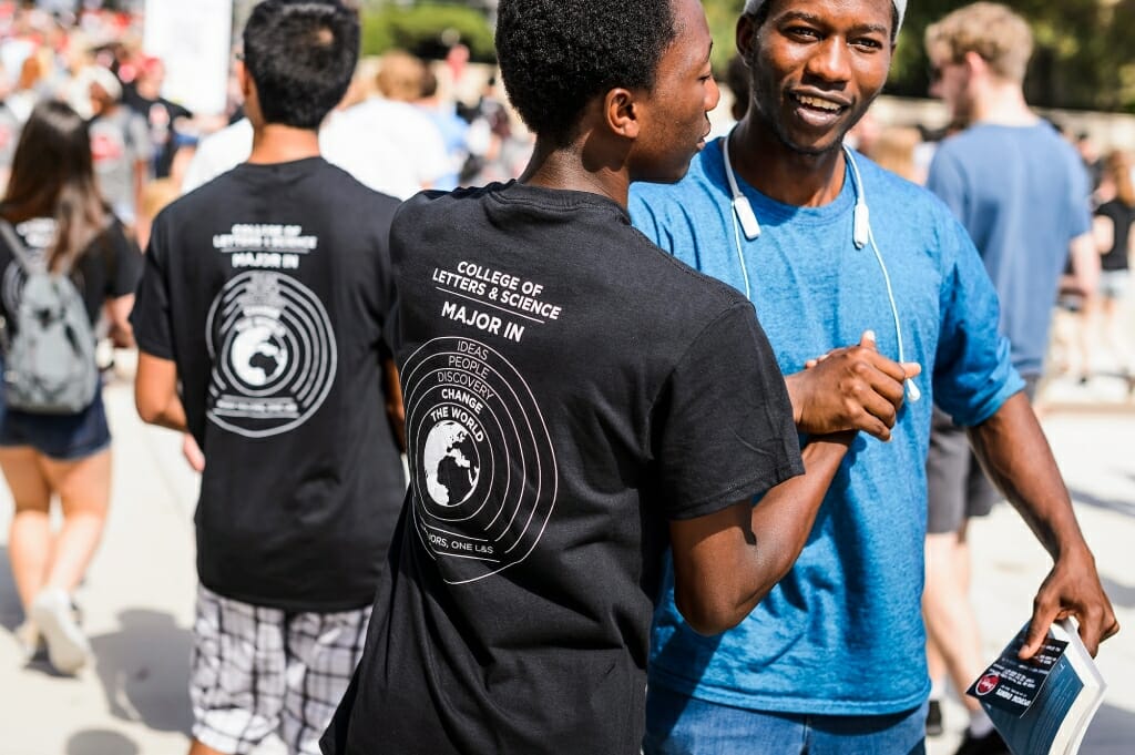 First-year students -- a few wearing College of Letters & Science-branded T-shirts -- depart convocation.