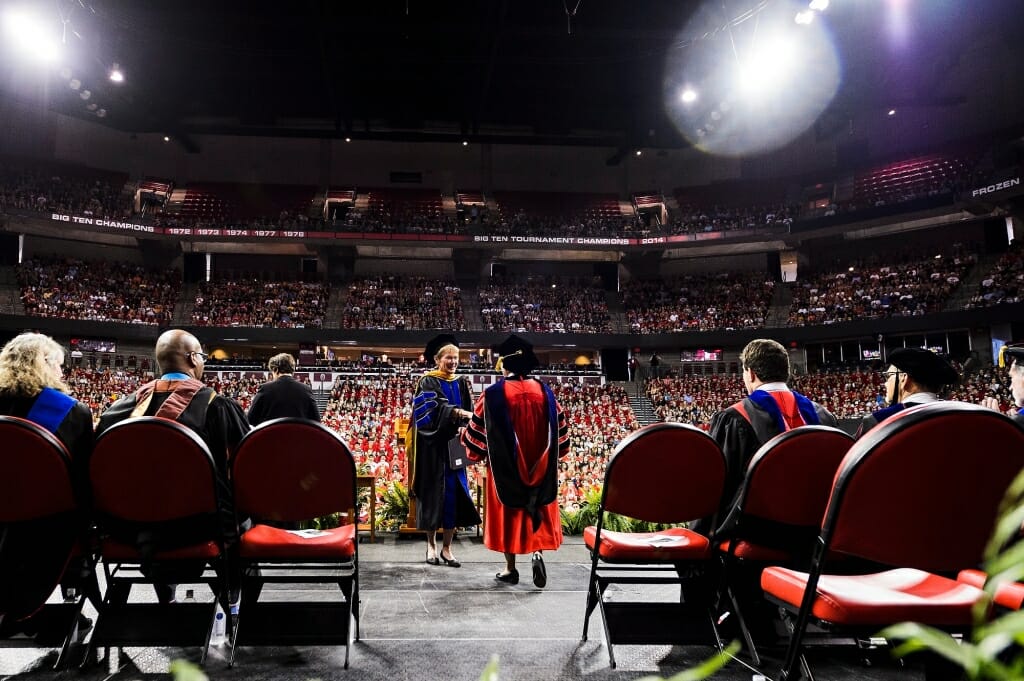 Provost Sarah Mangelsdorf, center, welcomes Chancellor Rebecca Blank to the podium.