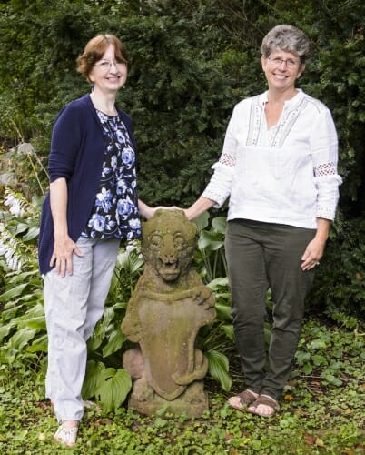 Photo: Bakke and Rice standing next to the gargoyle