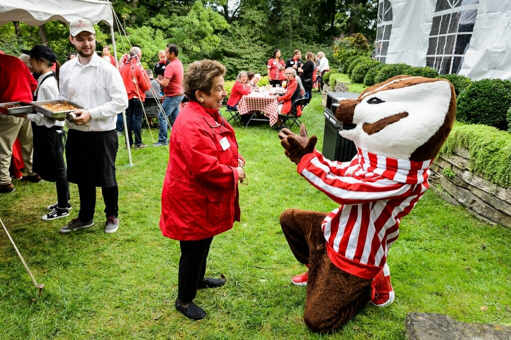 Photo of Bucky Badger welcoming Donna Shalala back to Olin House, the official residence of the chancellor, during a tailgate party Sept. 8. Shalala, who served as chancellor from 1988 to 1993, returned to campus for her induction into the UW Athletic Hall of Fame.