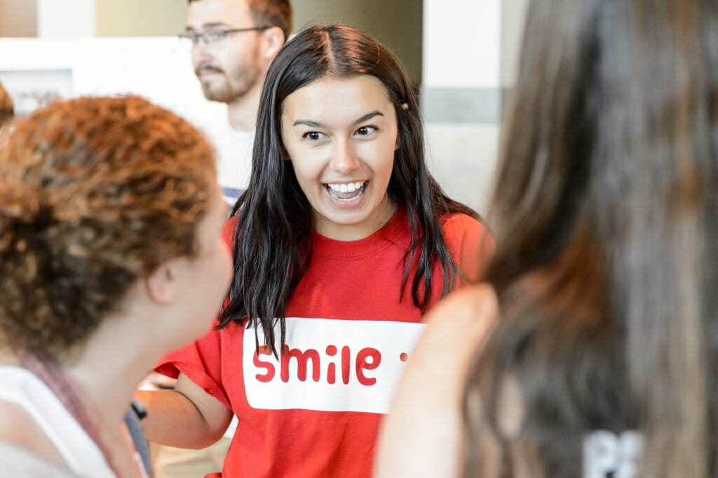 Ariana Double talks with students at the UW Smile Squad booth.